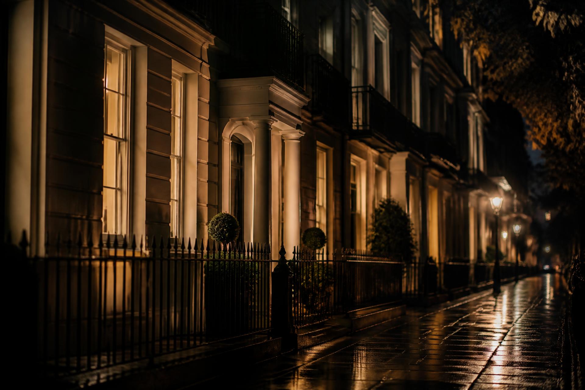 Lamplit Georgian townhouses on a wet London street at night